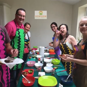 Group cooking session featuring insect-based recipes at a London event.