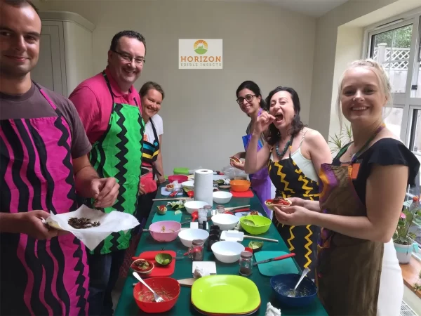 Group cooking session featuring insect-based recipes at a London event.