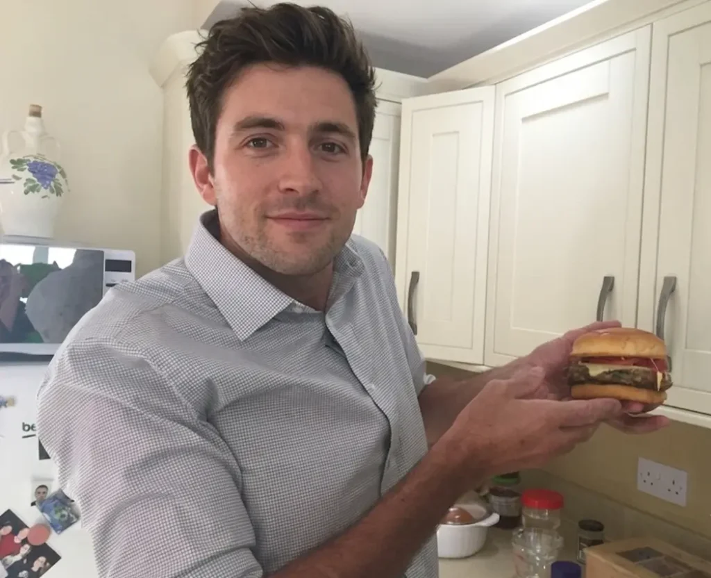 man with insect burger Man holding and edible insect burger